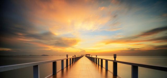 Wooded bridge in the port between sunrise