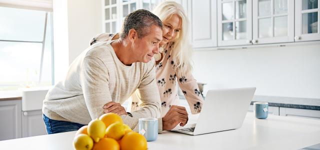 Healthy happy retired couple browsing the internet